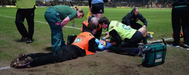 George North receives treatment on the pitch after being knocked out