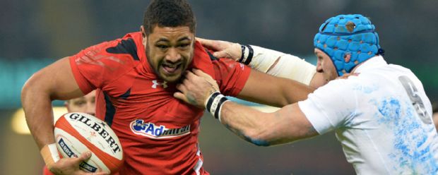 Wales number eight Taulupe Faletau holds off England's James Haskell