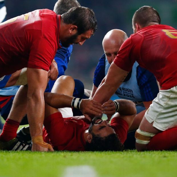 France wing Yoann Huget receives treatment for a serious knee injury sustained against Italy