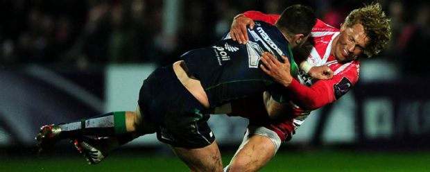 Connacht's Robbie Henshaw is tackled by Gloucester's Billy Twelvetrees