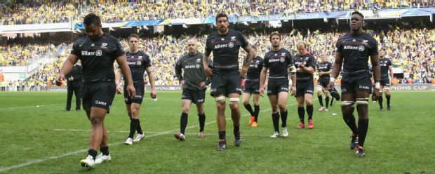 The Saracens players walk off the pitch dejected after defeat to Clermont