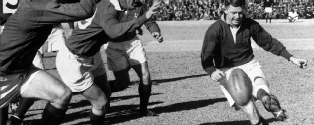 Bryn Meredith and Rees Williams of the British Lions rush T.A. Gentles, the Springbok scrum-half, in the first rugby test at Ellis Park, Johannesburg