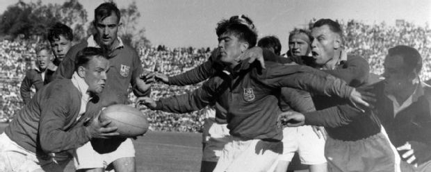 Bryn Meredith of the British Lions throws out a protective screen as British Lions' scrum-half Dicky Jeeps gets the ball from a line out