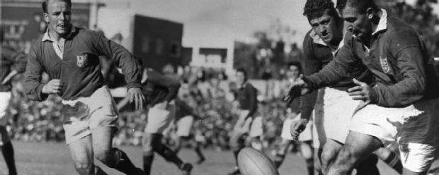 British Lions' Billy Williams is harassed by Salty Du Rand of the Springboks as he pases the ball to his scrum-half Dickie Jeeps