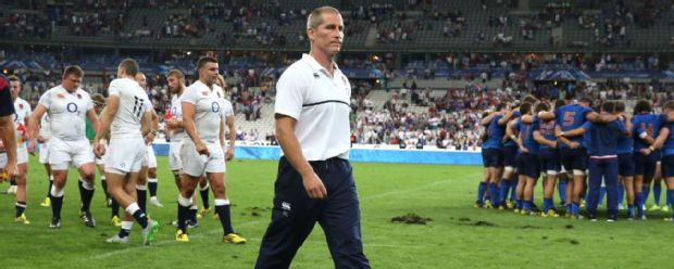 Stuart Lancaster walks dejectedly after England's defeat to France