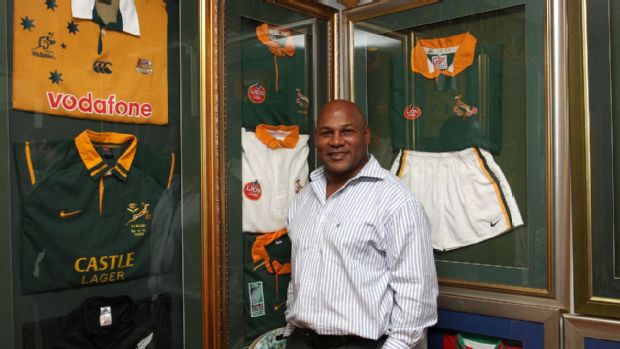 Chester Williams poses in front of memorabilia from his playing career
