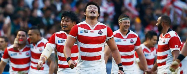 The Japan team savour the moment after beating South Africa