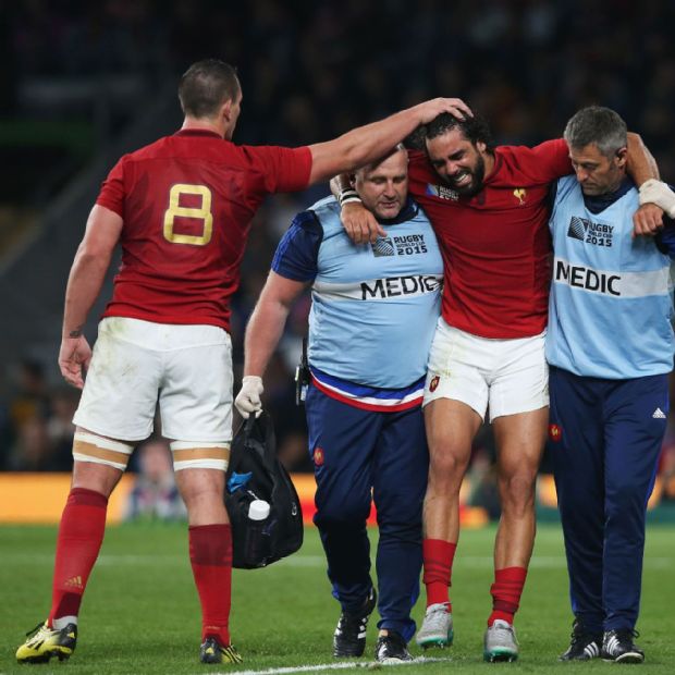 Louis Picamoles consoles Yoann Huget as the injured France wing is helped from the field