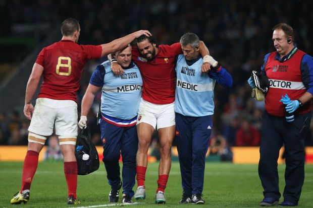 Louis Picamoles consoles Yoann Huget as the injured France wing is helped from the field