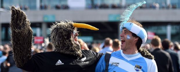 A New Zealand fan dressed as a Kiwi poses with an Argentina fan