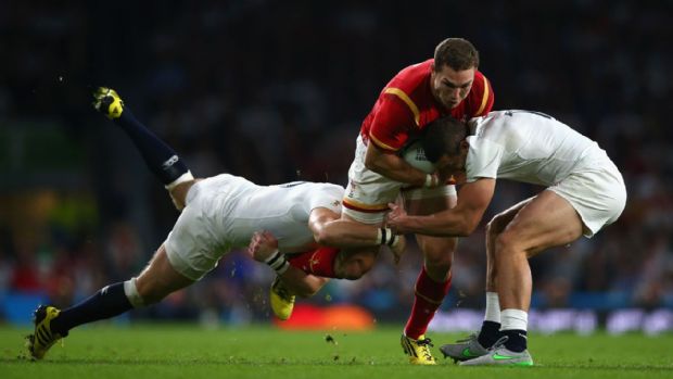 George North is tackled by Mike Brown and Jonny May