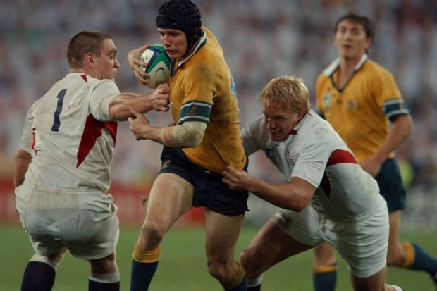 Stephen Larkham is tackled by England's Lewis Moody