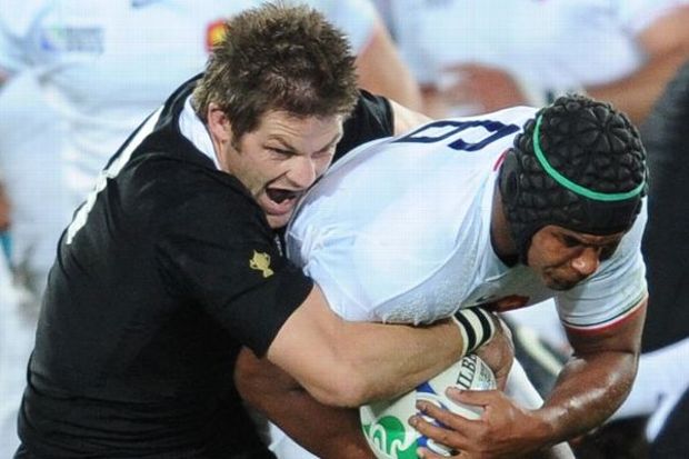 France's captain Thierry Dusautoir is tackled by New Zealand All Blacks captain Richie McCaw