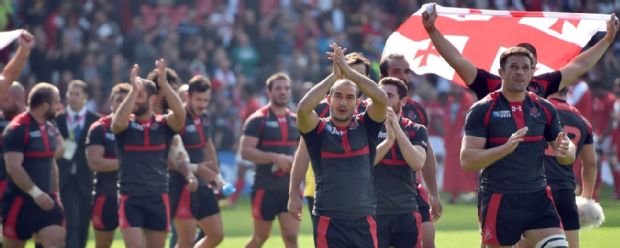 Georgia's players celebrate after winning a Pool C match of the 2015 Rugby World Cup between Tonga and Georgia