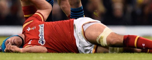 Justin Tipuric of Wales lies injured following a fall at a lineout