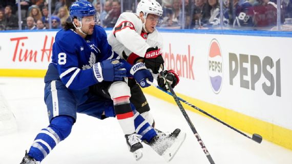Chris Tanev battling for the puck