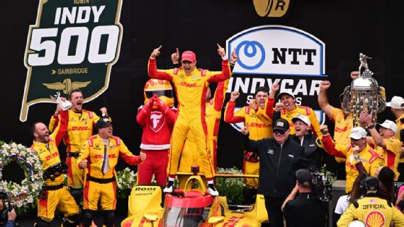 Alex Palou celebrates his Indianapolis 500 victory with the traditional milk swig.