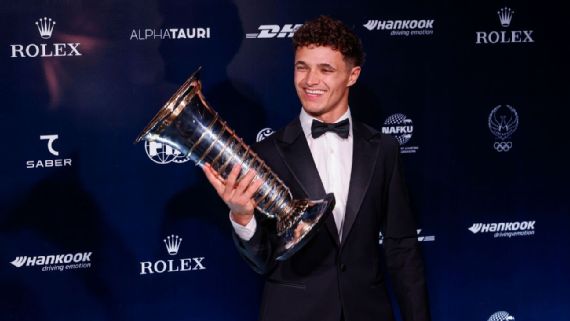 Lando Norris receives his world championship trophy at the FIA Awards in Tashkent.