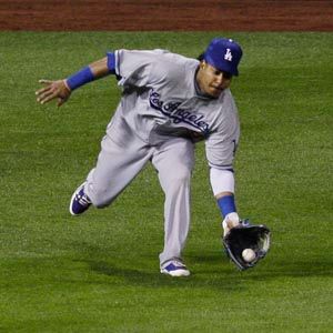 Los Angeles Dodger Manny Ramirez stretches his glove in the dugout prior to  the beginning of Game 3 of the NLCS against the Philadelphia Phillies in  Los Angeles on October 12, 2008. (