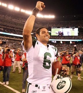 New York Jets quarterback Mark Sanchez rolls out of the pocket in