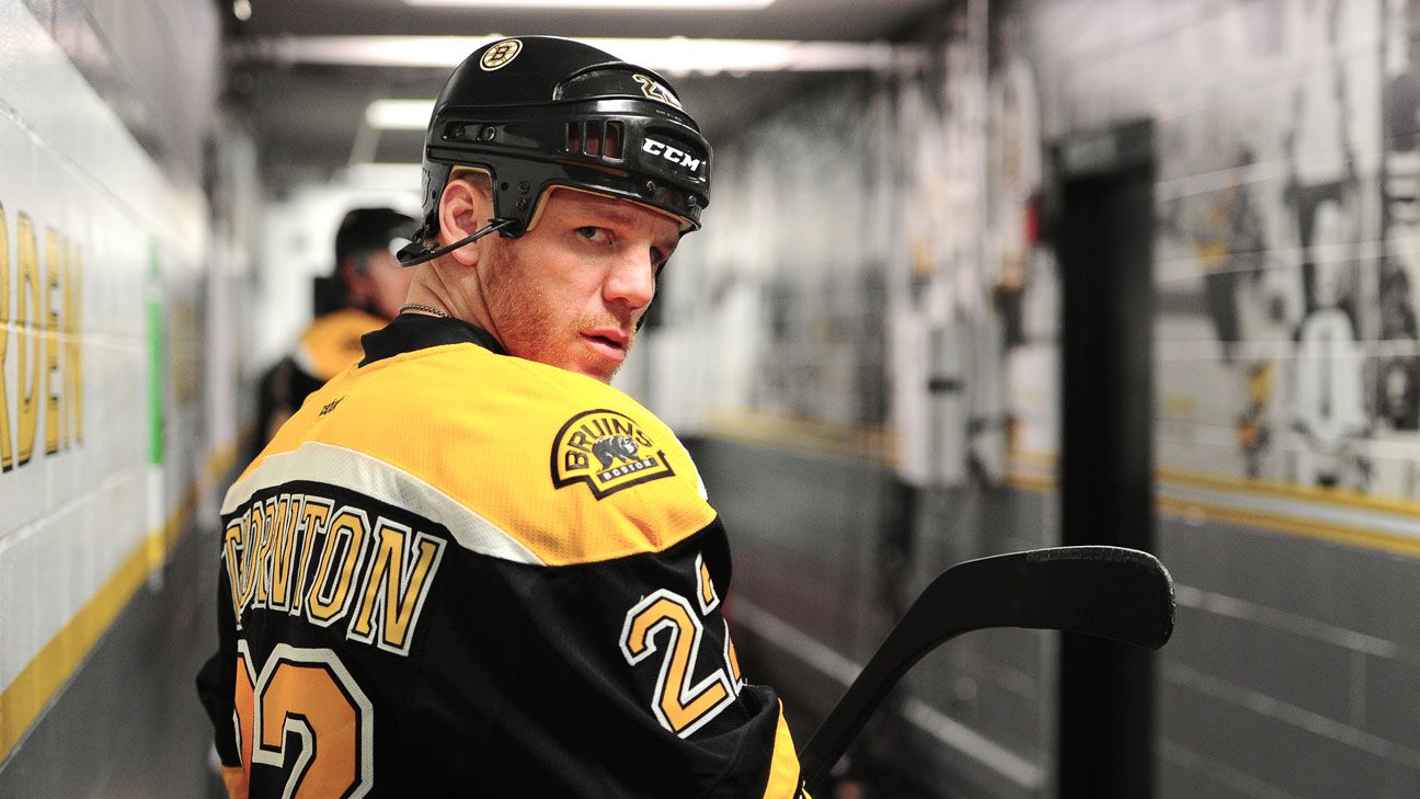 Boston Bruins player Shawn Thornton brings the Stanley Cup to