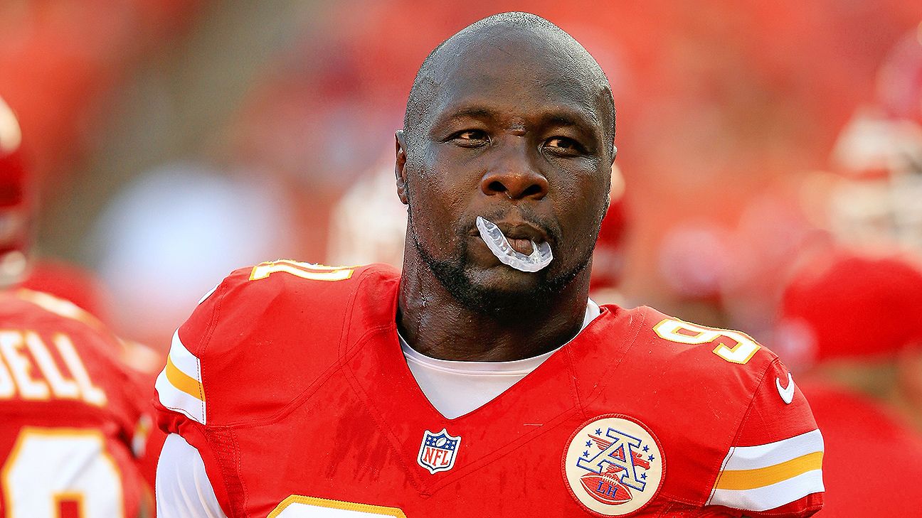 The Kansas City Chiefs - Tamba Hali gets a helping hand by a young