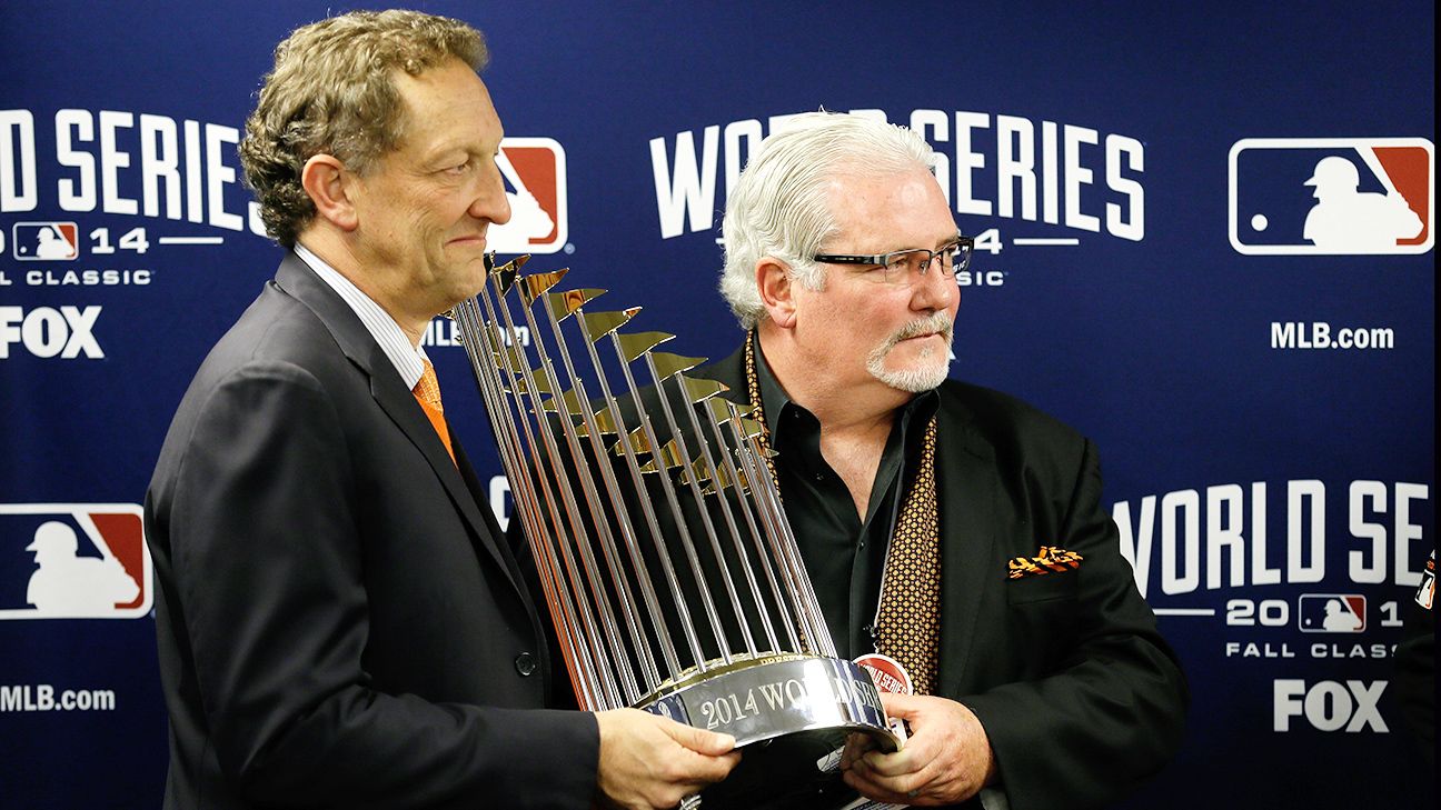 San Francisco Giants manager Bruce Bochey brings out the 2014 World Series  trophy to place it with those won in 2010 and 2012 after the World Series  Parade in San Francisco on