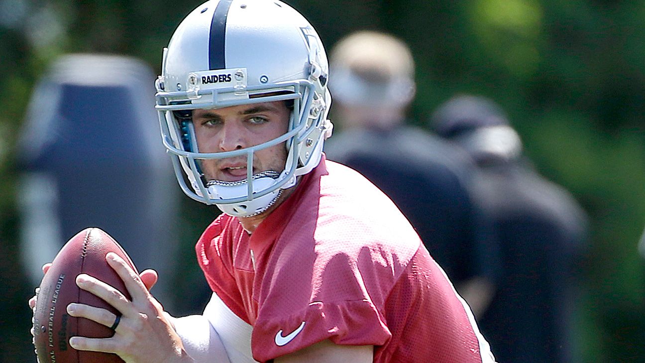 Oakland Raiders' Derek Carr tosses a few passes, still little