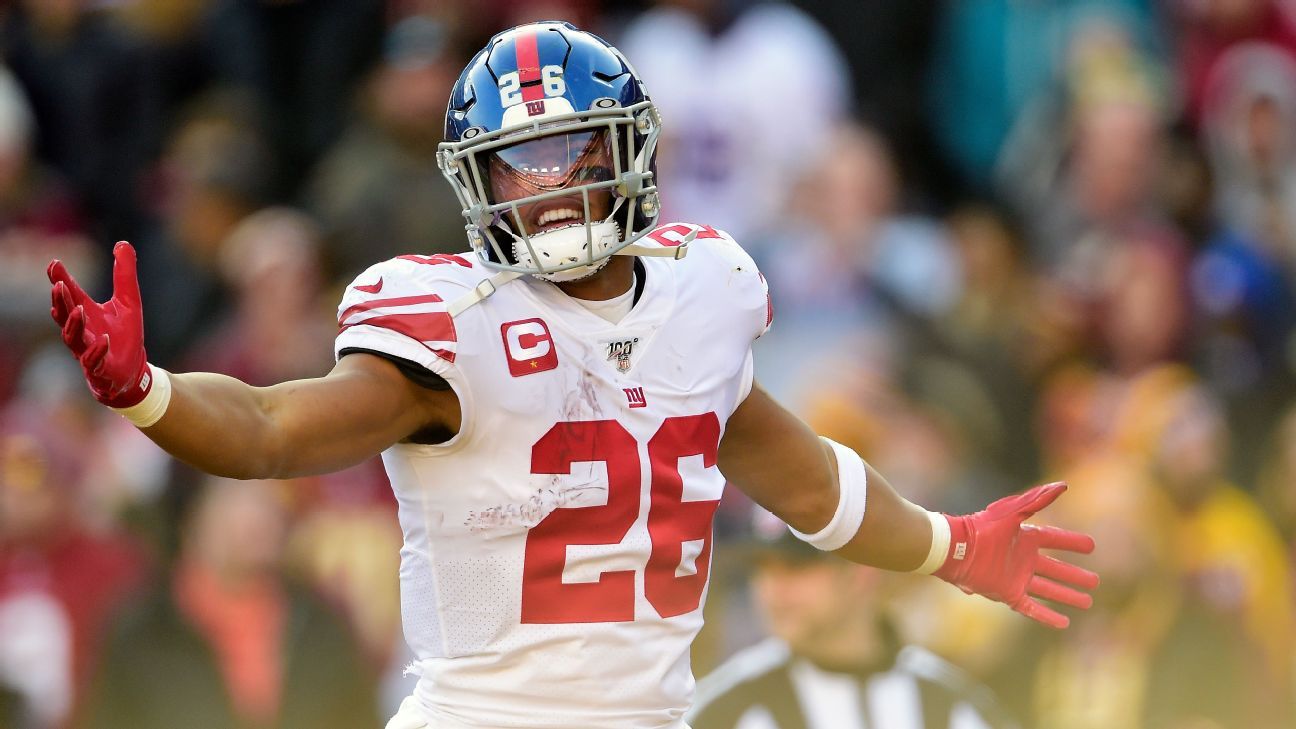 New York Giants running back Saquon Barkley (26) keeps his hands warm while  on the sidelines in the third quarter against the Washington Redskins at  FedEx Field in Landover, Maryland on Sunday