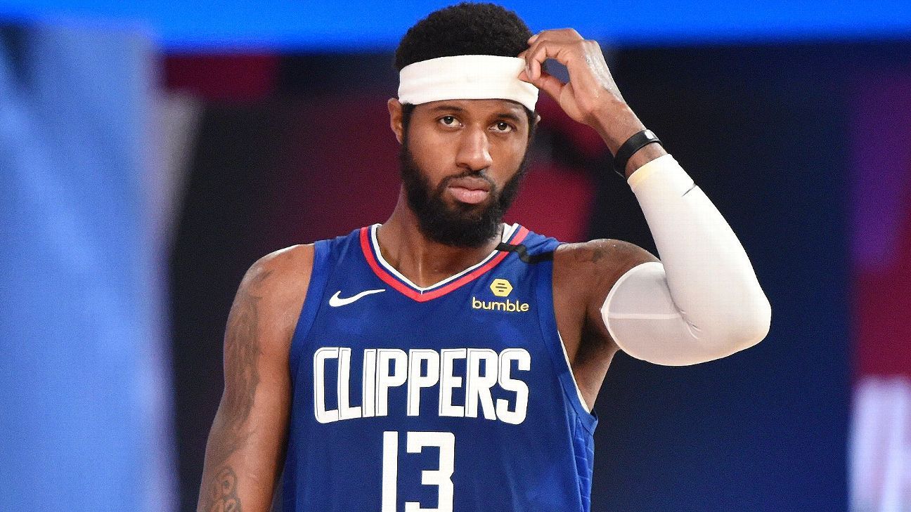 Los Angeles Clippers guard Paul George, left, dunks the ball against  Indiana Pacers guard Justin Holiday, back, during the first quarter of an  NBA basketball game, Sunday, Jan. 17, 2021, in Los