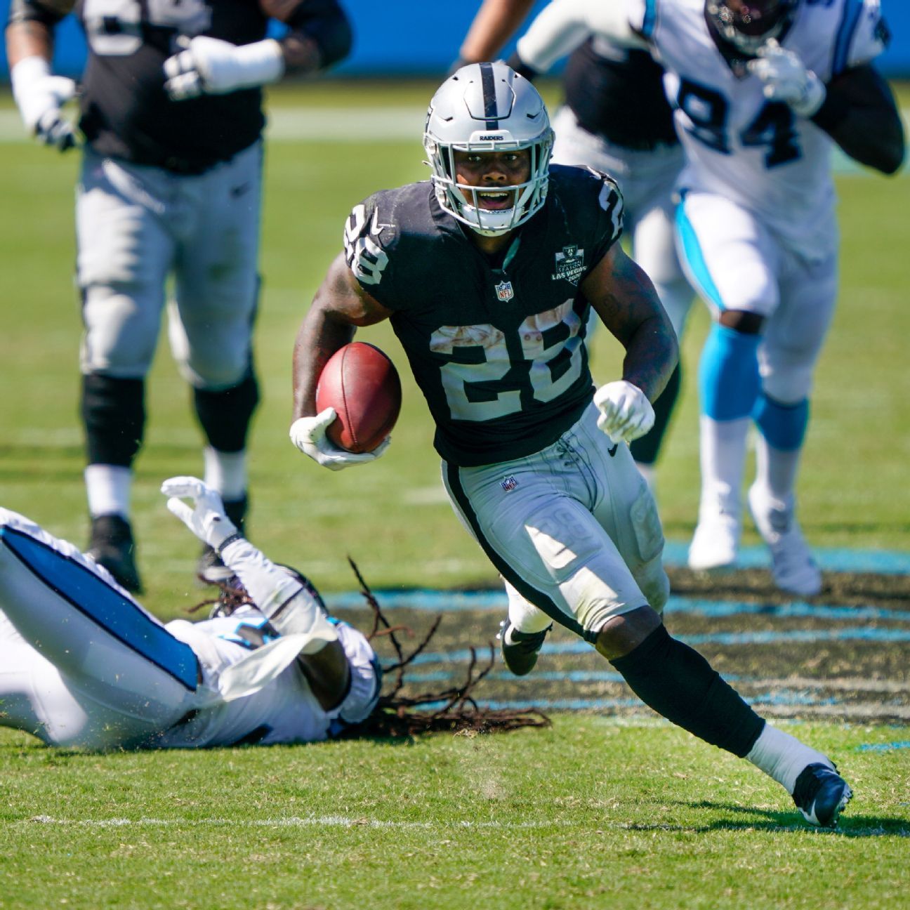 Las Vegas Raiders running back Josh Jacobs (28) stiff arms New York Giants  cornerback James Bra …