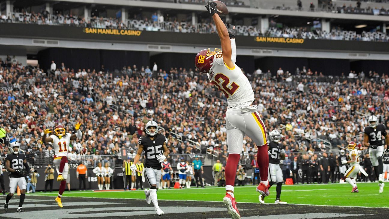 Washington Commanders tight end Logan Thomas makes a leaping grab