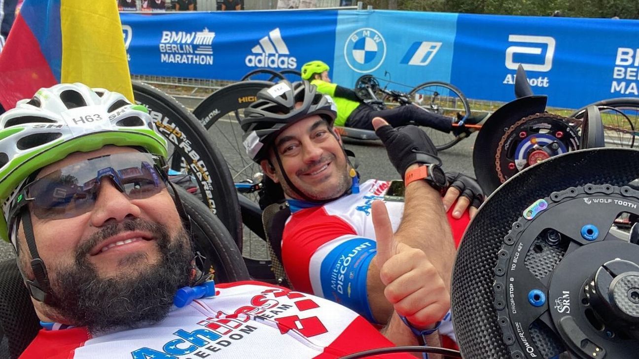 Paralyzed marathoner Pierry Duvan Ramirez keeps eye on his finish line while helping others cross theirs