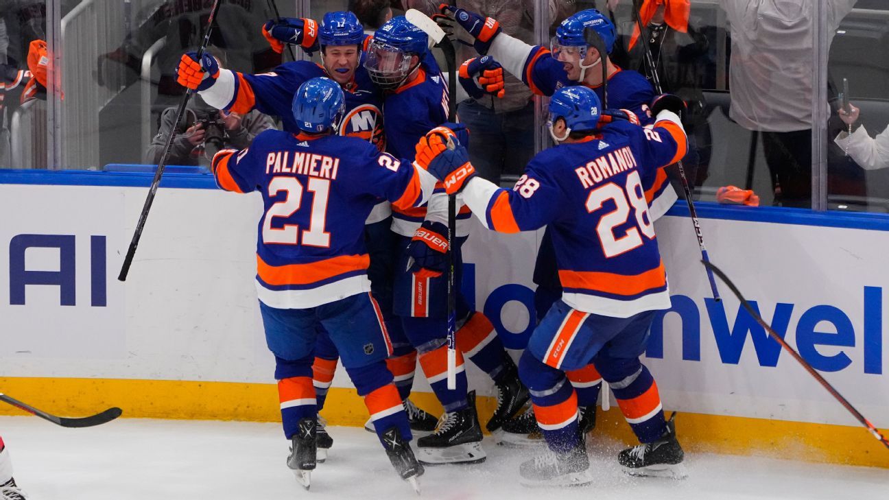 New York Islanders defenseman Scott Mayfield (24) celebrates his goal with  his teammates during the third period of an NHL hockey game against the  Florida Panthers , Saturday, Nov. 9, 2019, in