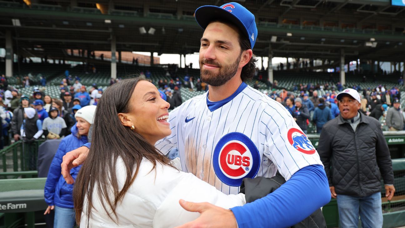 Cubs fan behind one-liner shirts